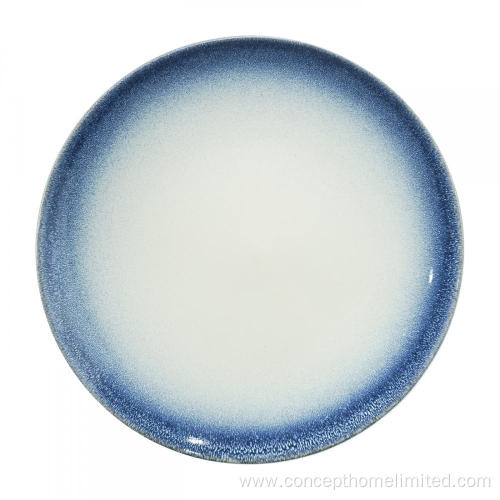 Reactive glazed stoneware dinner set with blue rim